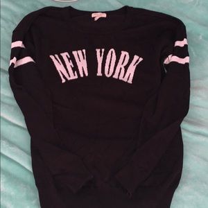 Black and white sweater with the “New York” logo